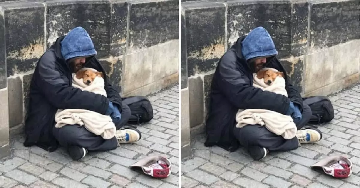 The homeless man embraces his dog in the chill of winter, a truly wonderful act